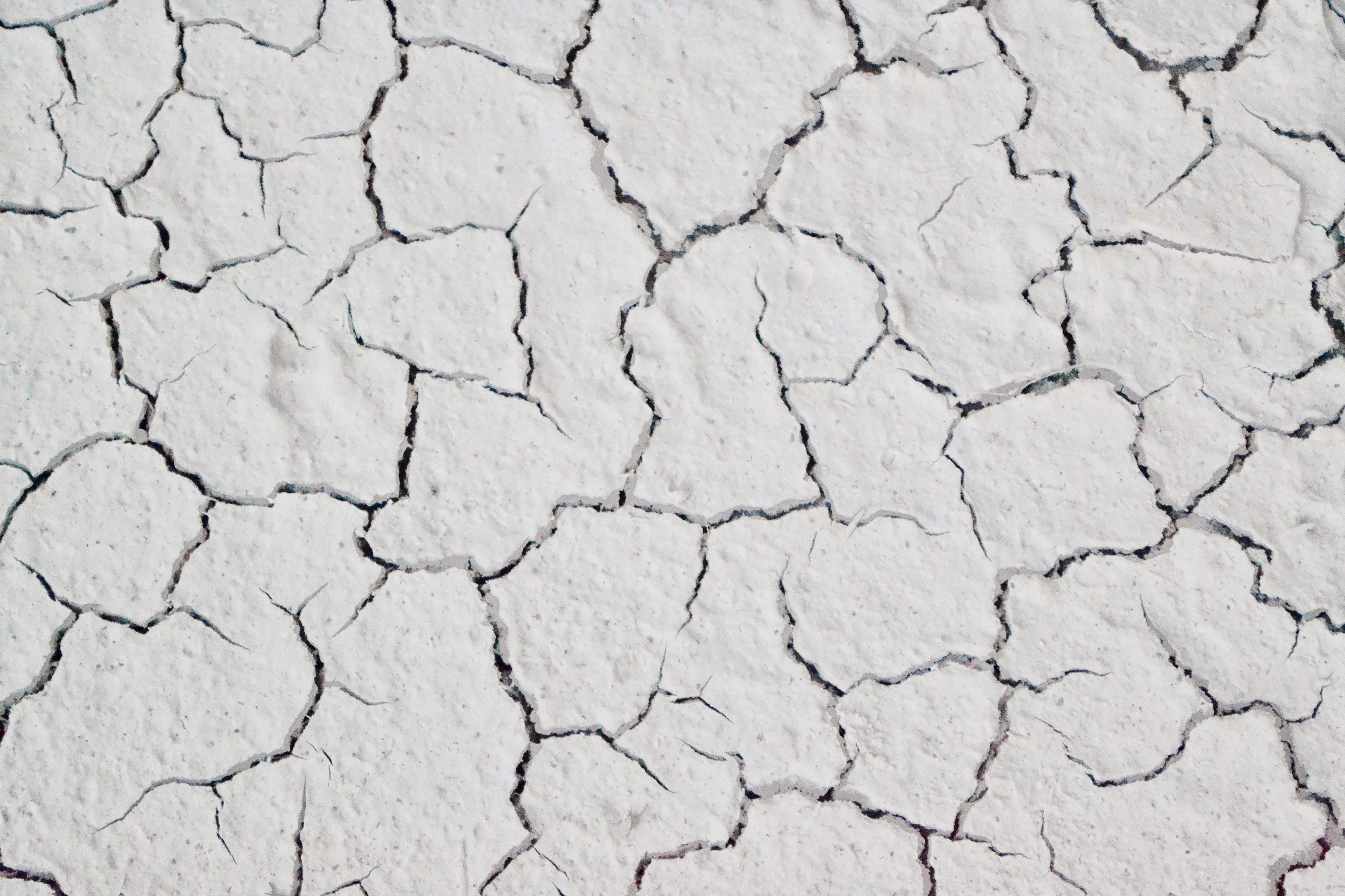 White painted surface with black cracks running through it